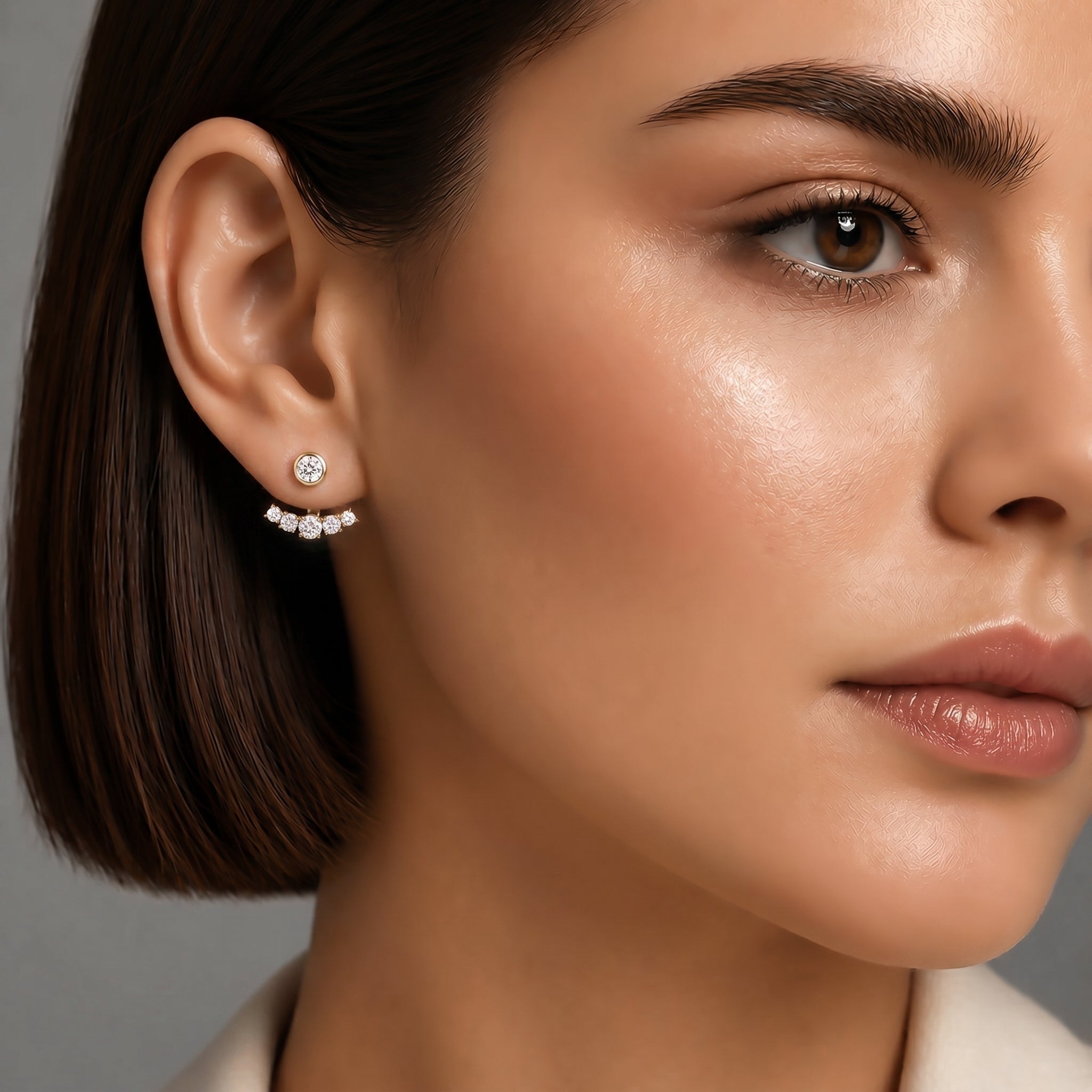 Stylish image of female model wearing 14K gold diamond ear jackets in a luxurious setting, showcasing elegance.